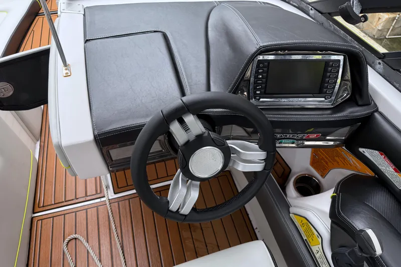 Slide: The Image of 2015 Nautique Super Air Nautique G23 Coastal Edition dashboard with steering wheel and control panel. - 6
