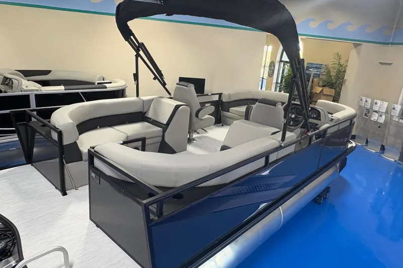 Slide: The Image of 2026 Dockside 22DQ pontoon boat with sleek design and spacious seating in showroom. - 4