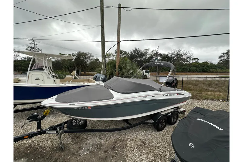 Slide: The Image of 2021 Tahoe 210 S boat on trailer, covered and parked outdoors. - 9