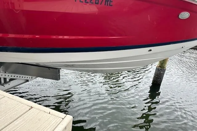 Slide: The Image of Red 2016 Cobalt A28 boat docked above water, showcasing sleek hull design. - 10