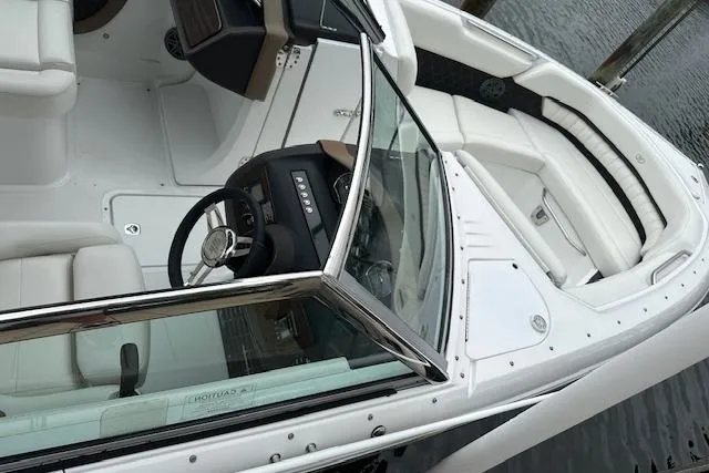 Slide: The Image of 2016 Cobalt A28 boat interior with white seating and sleek dashboard design. - 28