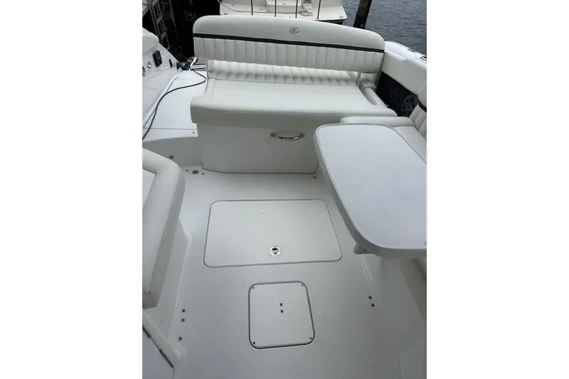 Slide: The Image of 2016 Cobalt A28 boat interior with white seating and table. - 32