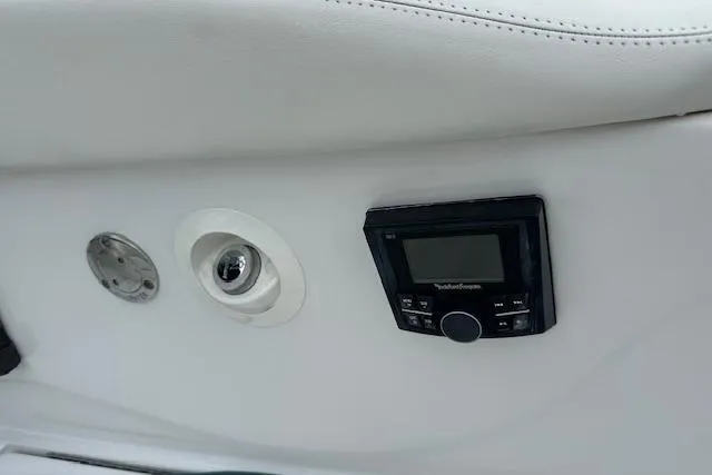 Slide: The Image of 2016 Cobalt A28 boat interior with control panel and audio system. - 35
