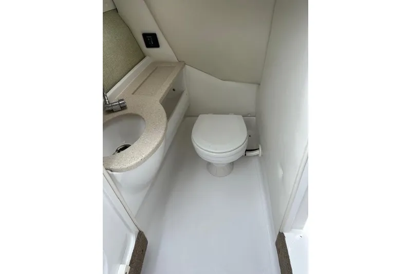 Slide: The Image of 2016 Cobalt A28 boat interior bathroom with sink and toilet. - 38
