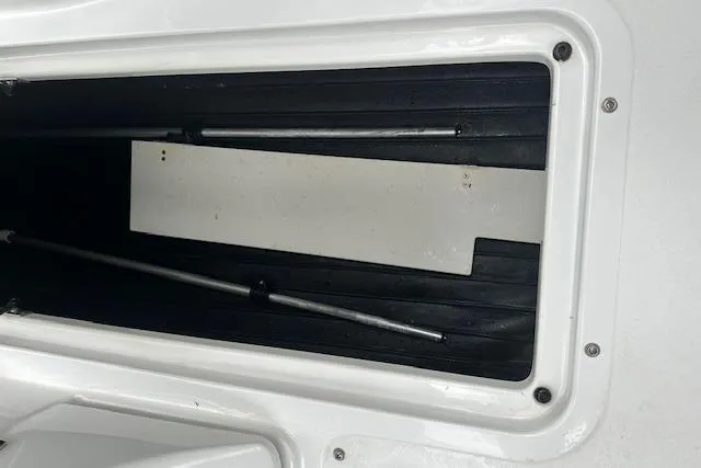 Slide: The Image of Storage compartment of a 2016 Cobalt A28 boat, featuring a sleek black interior. - 42