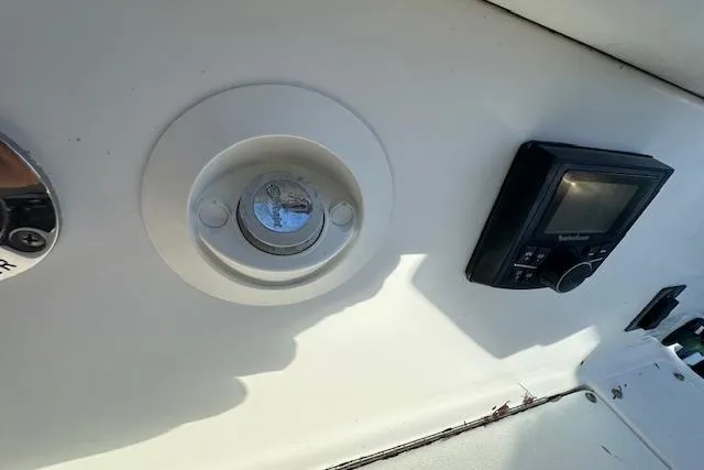 Slide: The Image of 2016 Cobalt A28 boat dashboard with control panel and gauge. - 45