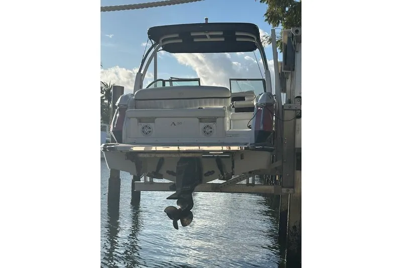 Slide: The Image of 2016 Cobalt A28 boat docked, rear view with clear sky background. - 55