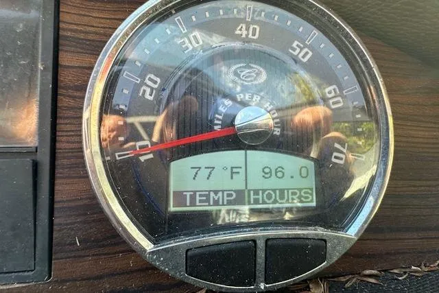 Slide: The Image of Gauge display of 2016 Cobalt A28 showing 77°F temperature and 96 hours. - 59
