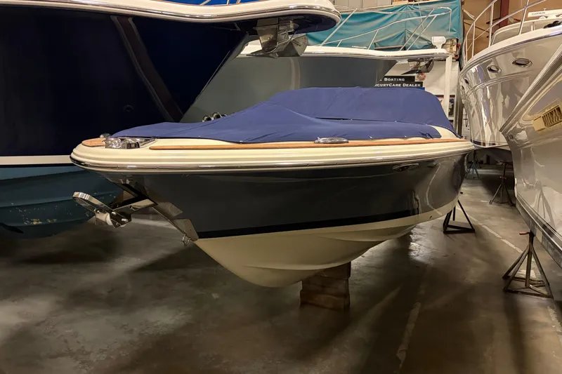 The Image of 2020 Chris-Craft Launch 28 GT boat in storage, covered with a blue tarp. - 0