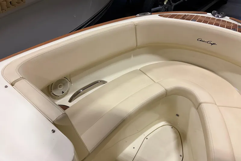 Slide: The Image of 2020 Chris-Craft Launch 28 GT boat interior with cream leather seating and speaker. - 13