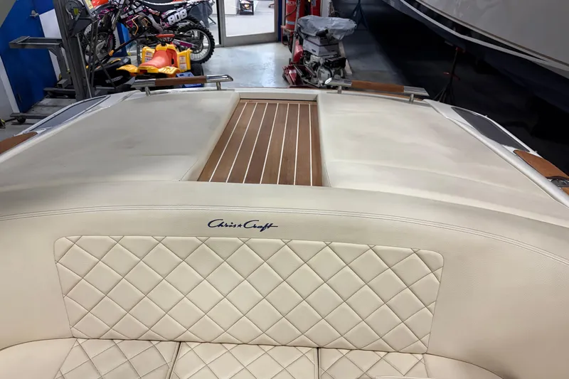 Slide: The Image of 2020 Chris-Craft Launch 28 GT boat interior with quilted leather seating and wood accents. - 29
