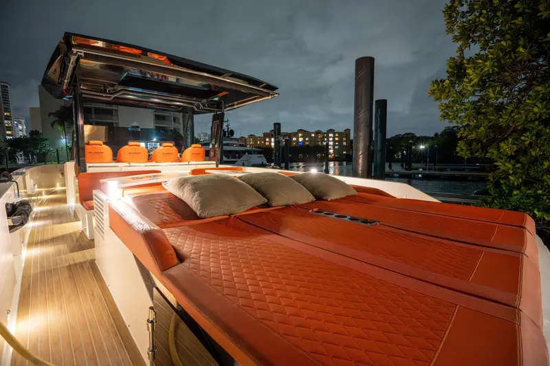 Slide: The Image of 2023 De Antonio Yachts D42 Open luxury yacht with elegant deck and plush seating at night. - 12