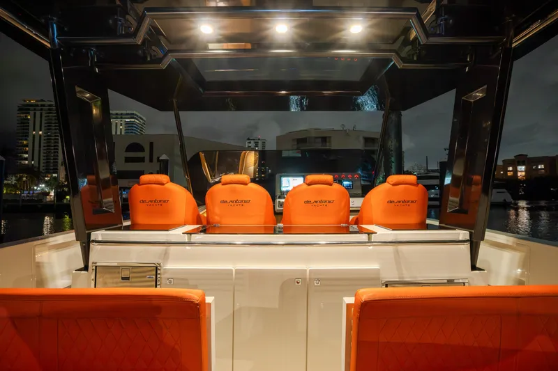 Slide: The Image of 2023 De Antonio Yachts D42 Open with illuminated cockpit and vibrant orange seating. - 15