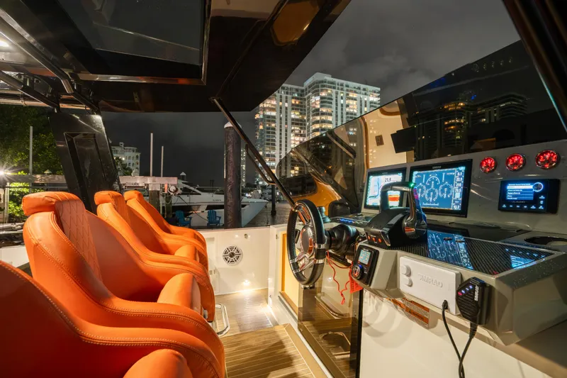 Slide: The Image of 2023 De Antonio Yachts D42 Open cockpit with orange seats and advanced navigation system. - 16