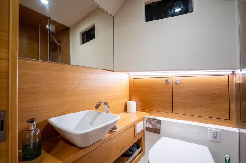 Slide: The Image of Luxurious bathroom interior of 2023 De Antonio Yachts D42 Open, featuring modern sink and wood accents. - 18