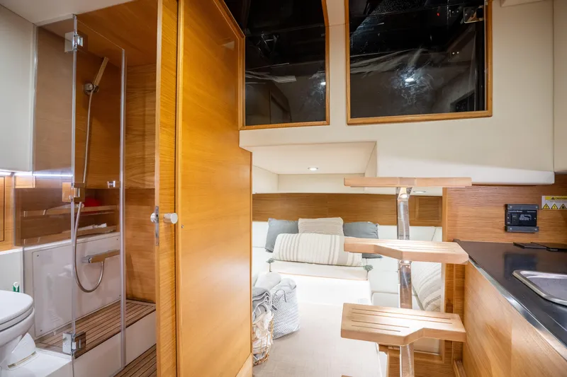Slide: The Image of Luxurious interior of 2023 De Antonio Yachts D42 Open, featuring modern wood finishes and cozy seating. - 24