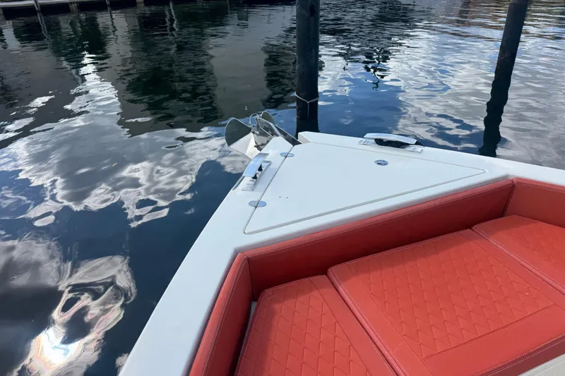 Slide: The Image of 2022 De Antonio Yachts D42 Open with red seating, docked on calm water. - 3