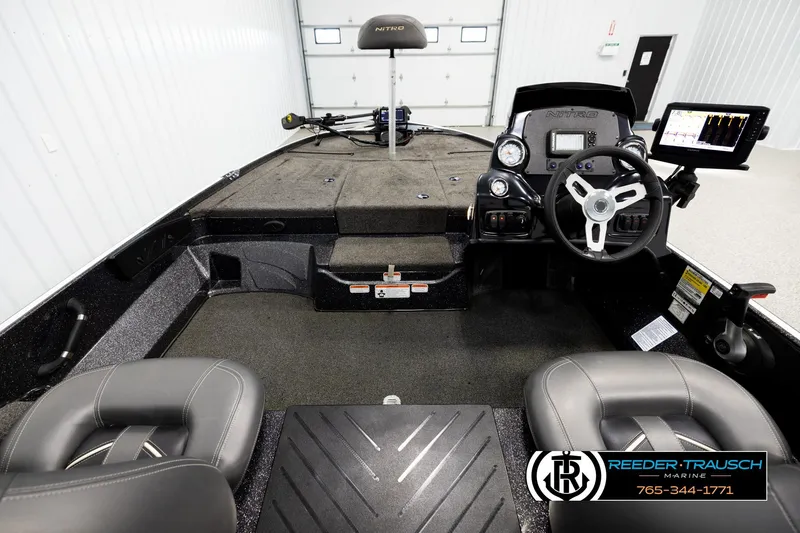 Slide: The Image of Interior of a 2021 Ntiro Z17 boat with steering wheel and control panel. - 13