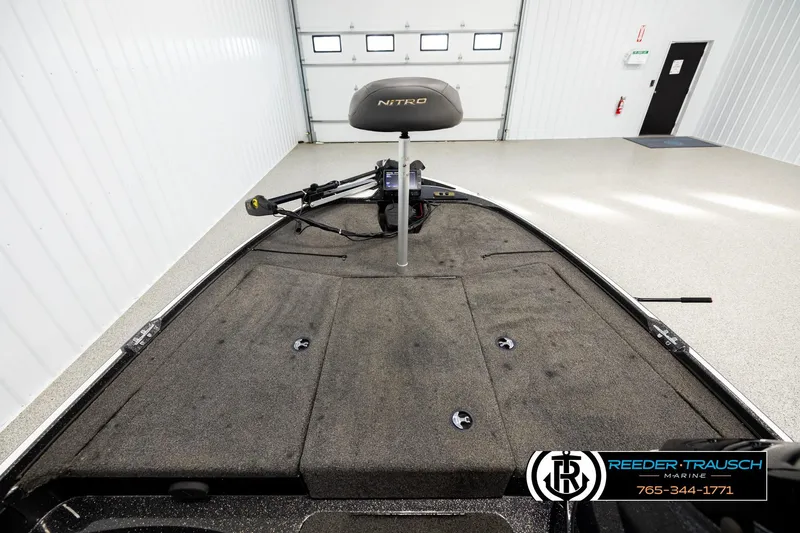 Slide: The Image of 2021 Ntiro Z17 boat interior with fishing seat and trolling motor in a showroom. - 14