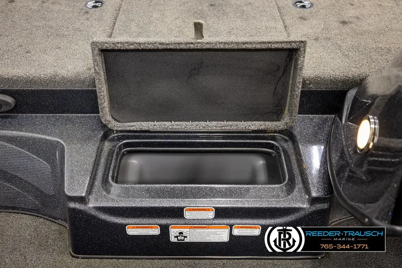 Slide: The Image of Open storage compartment in 2021 Ntiro Z17 boat, featuring Reeder-Trausch Marine branding. - 21