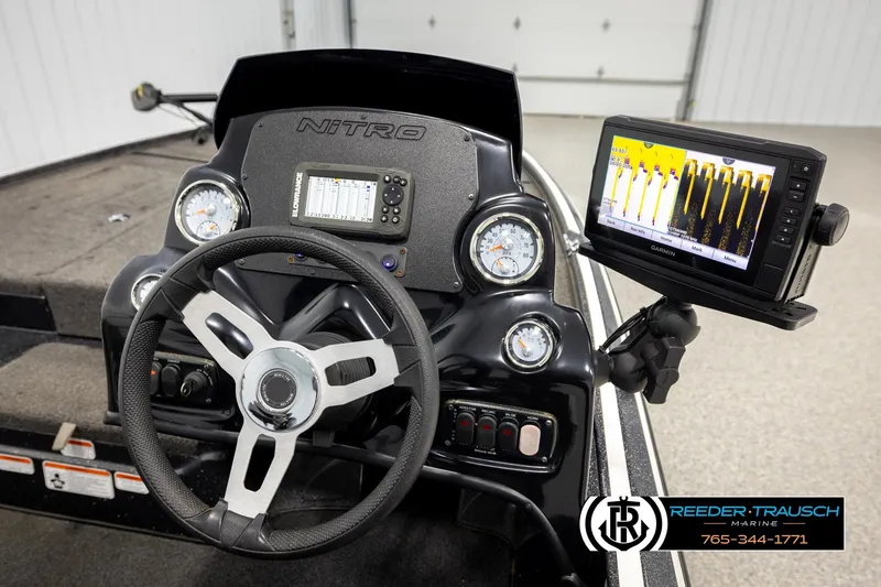Slide: The Image of Cockpit of 2021 Ntiro Z17 boat with steering wheel and Garmin display. - 28