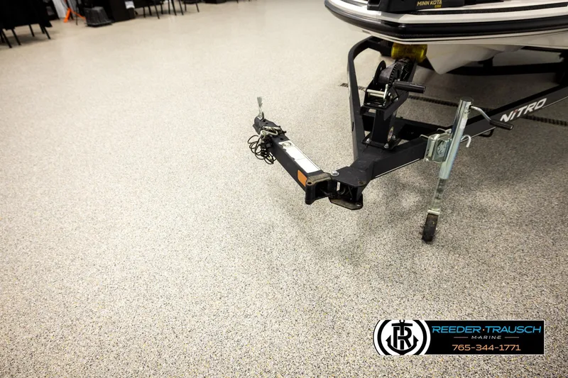 Slide: The Image of Trailer hitch of a 2021 Ntiro Z17 boat on showroom floor, Reeder-Trausch Marine logo visible. - 49
