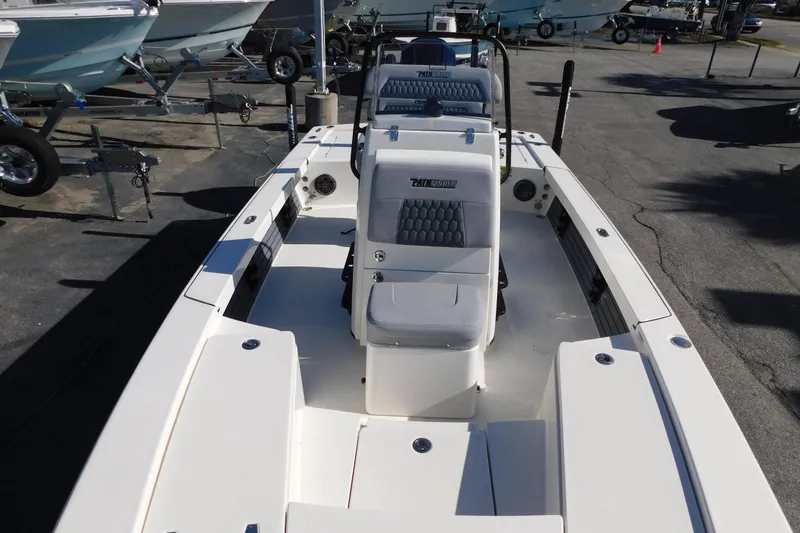 Slide: The Image of 2026 Pathfinder 2300 HPS boat, white interior, parked on a trailer in a marina. - 12