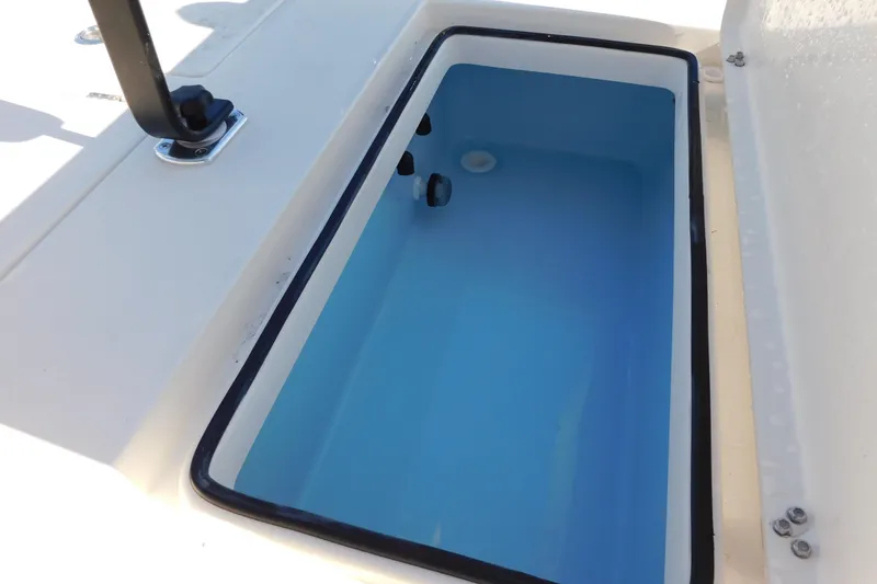 Slide: The Image of Livewell compartment on 2026 Pathfinder 2300 HPS boat, featuring a clean, blue interior. - 15
