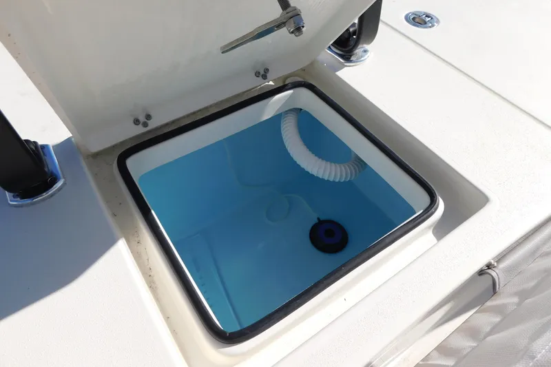 Slide: The Image of Livewell compartment on 2026 Pathfinder 2300 HPS boat, featuring a blue interior and white hose. - 16