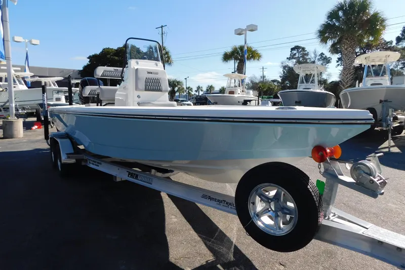 Slide: The Image of 2026 Pathfinder 2300 HPS boat on trailer, displayed outdoors with palm trees. - 18