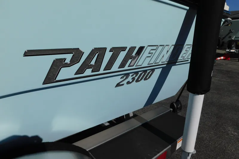 Slide: The Image of 2026 Pathfinder 2300 HPS boat logo on light blue hull. - 25
