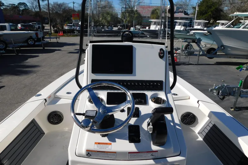 Slide: The Image of 2026 Pathfinder 2300 HPS boat dashboard with steering wheel and control panel. - 3