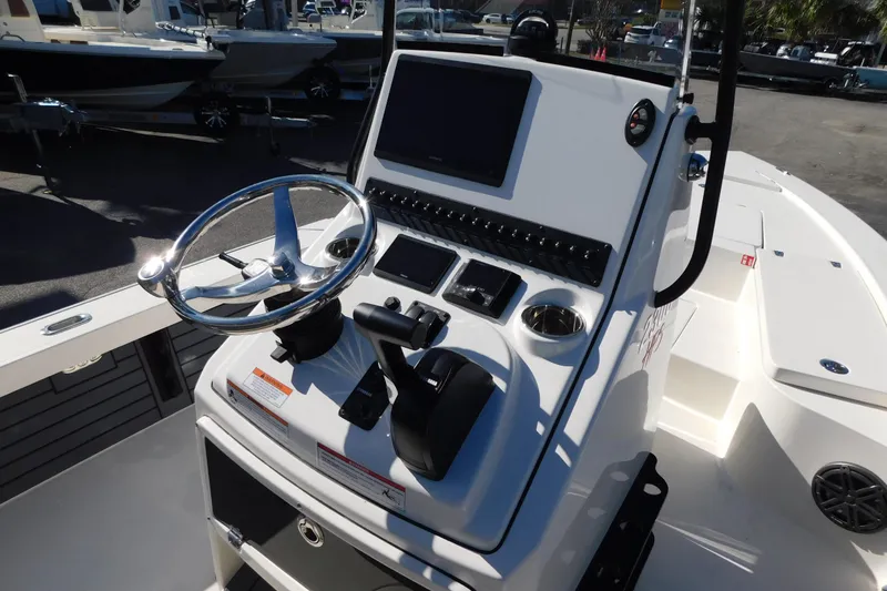 Slide: The Image of 2026 Pathfinder 2300 HPS boat console with steering wheel and control panel. - 4