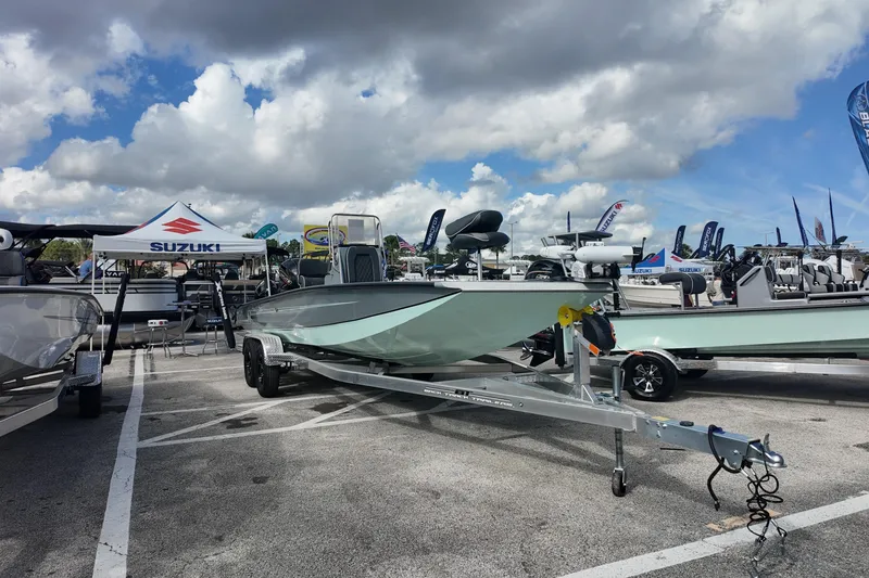 Slide: The Image of 2026 Xpress H24B Bay boat on trailer at outdoor exhibition. - 1