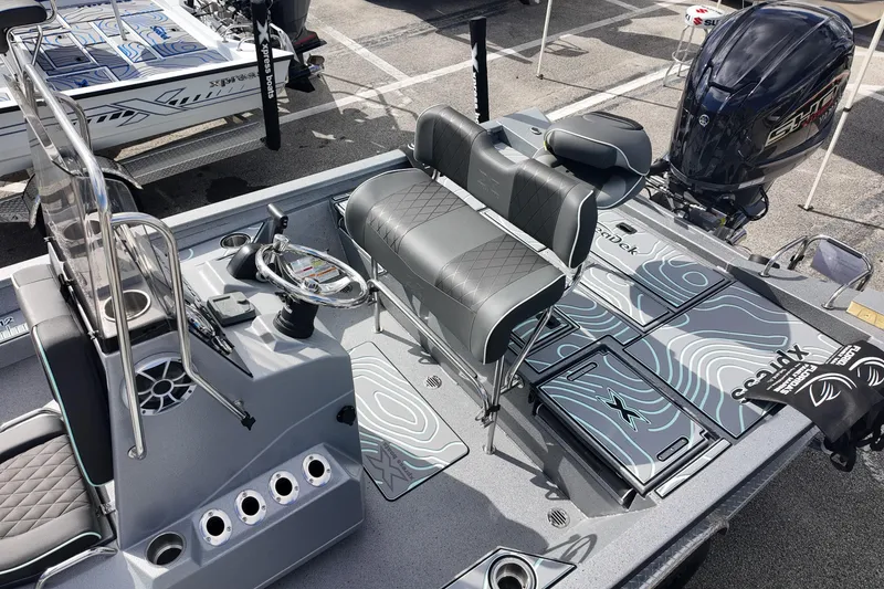 Slide: The Image of 2026 Xpress H24B Bay boat interior with modern seating and steering console. - 10
