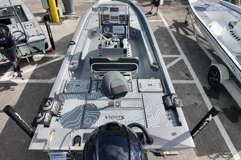 Slide: The Image of 2026 Xpress H24B Bay boat with modern design and advanced features, displayed outdoors. - 12