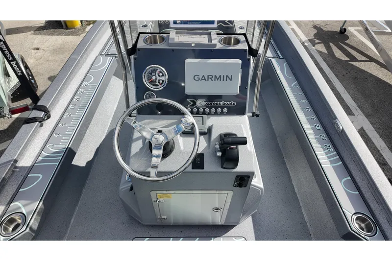 Slide: The Image of 2026 Xpress H24B Bay boat console with Garmin navigation system and steering wheel. - 13