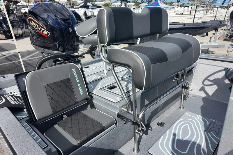 Slide: The Image of 2026 Xpress H24B Bay boat interior with seating and motor, showcasing modern design. - 14
