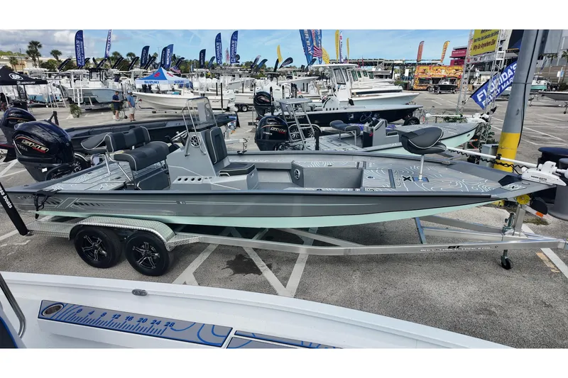 Slide: The Image of 2026 Xpress H24B Bay boat displayed at a marina with other vessels. - 2