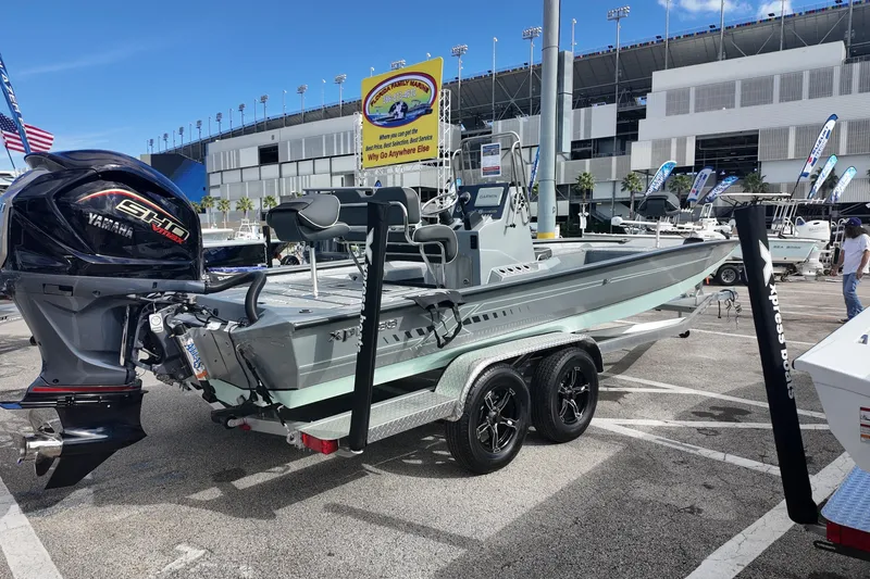 Slide: The Image of 2026 Xpress H24B Bay boat with Yamaha engine on display at an outdoor event. - 3