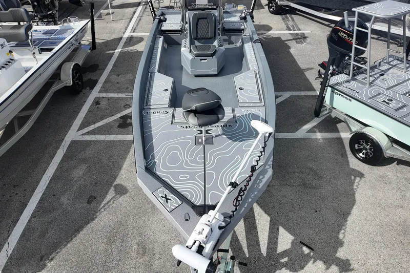 Slide: The Image of 2026 Xpress H24B Bay boat with modern design in a parking lot. - 7