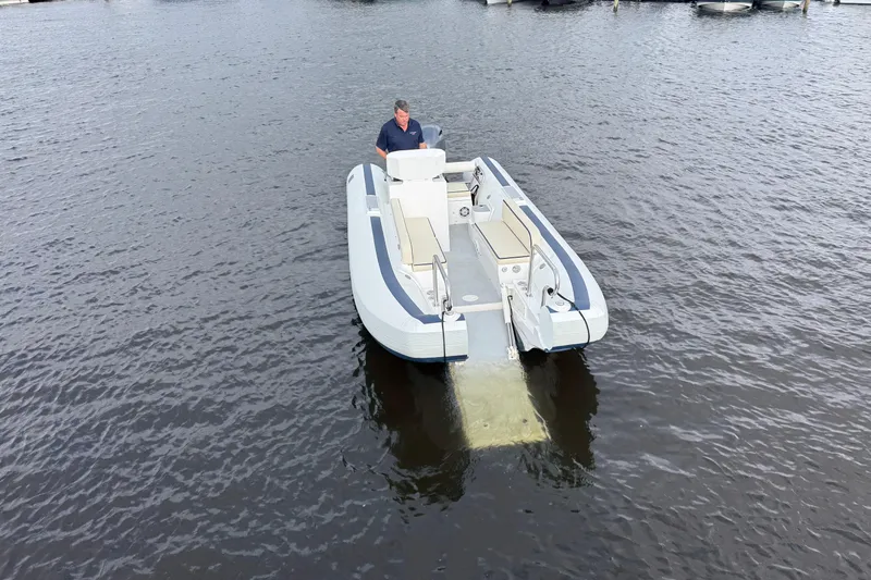 Slide: The Image of 2024 Novurania Catamaran 20 on water, featuring sleek design and spacious seating. - 7