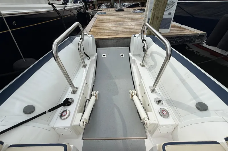 Slide: The Image of 2024 Novurania Catamaran 20 boat interior with stainless steel railings and dock view. - 9