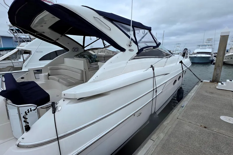 Slide: The Image of 2002 Regal Commodore 4260 yacht docked at marina, featuring sleek design and spacious seating. - 10