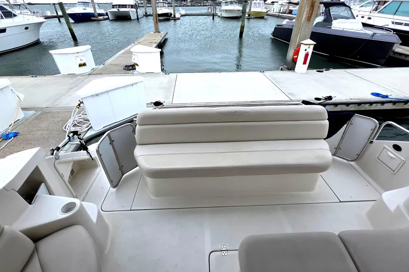 Slide: The Image of 2002 Regal Commodore 4260 yacht interior with seating, docked at marina. - 15