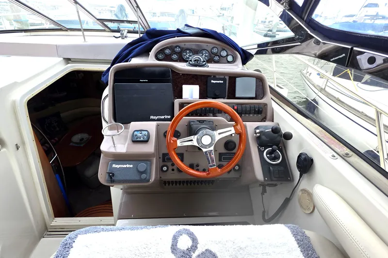 Slide: The Image of 2002 Regal Commodore 4260 yacht cockpit with steering wheel and navigation equipment. - 16