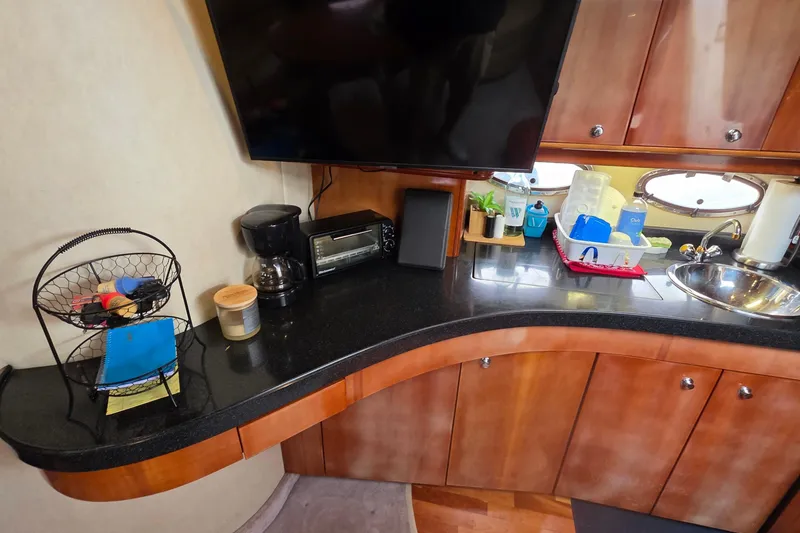 Slide: The Image of 2002 Regal Commodore 4260 yacht kitchen with countertop, sink, and appliances. - 17