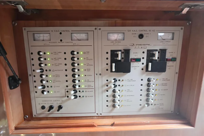 Slide: The Image of Electrical control panel of a 2002 Regal Commodore 4260 boat, featuring various switches and indicators. - 19