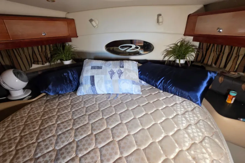 Slide: The Image of Luxurious cabin interior of 2002 Regal Commodore 4260 yacht with plush bedding and decor. - 25