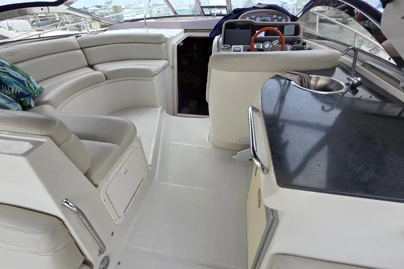 Slide: The Image of Interior of 2002 Regal Commodore 4260 yacht with seating and kitchenette. - 29